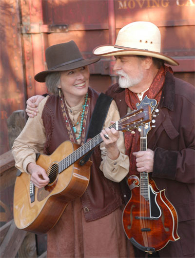 Man & Woman with guitars dressed in western clothes photo