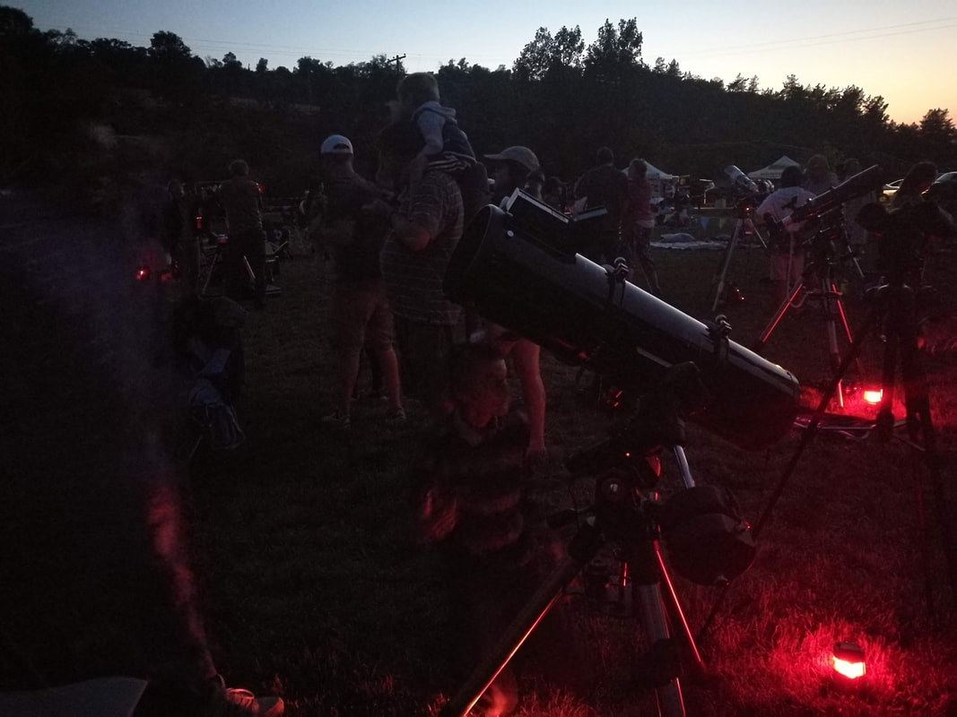 People with telescopes for dark sky network photo