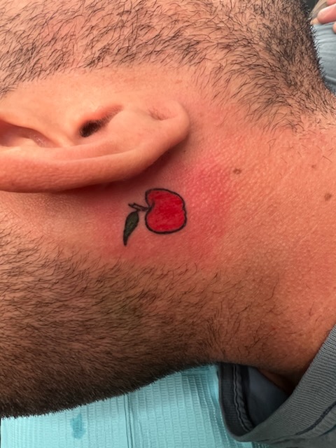 Apple tattoo from Fawn House Tattoo photo
