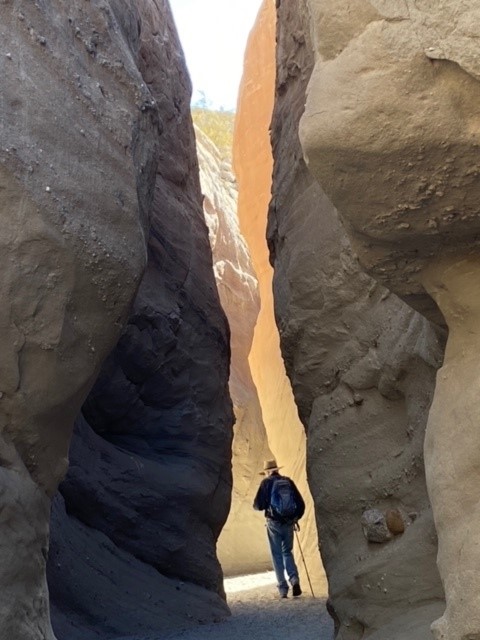 California Overland Desert Excursions man in between two rocks photo