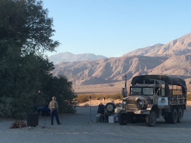 California Overland Desert Excursions Truck and man in front of mountain photo