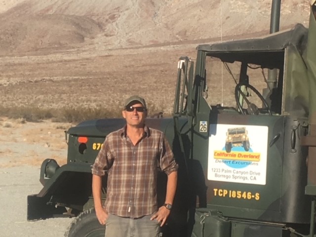 California Overland Desert Excursions Man standing in front of truck photo