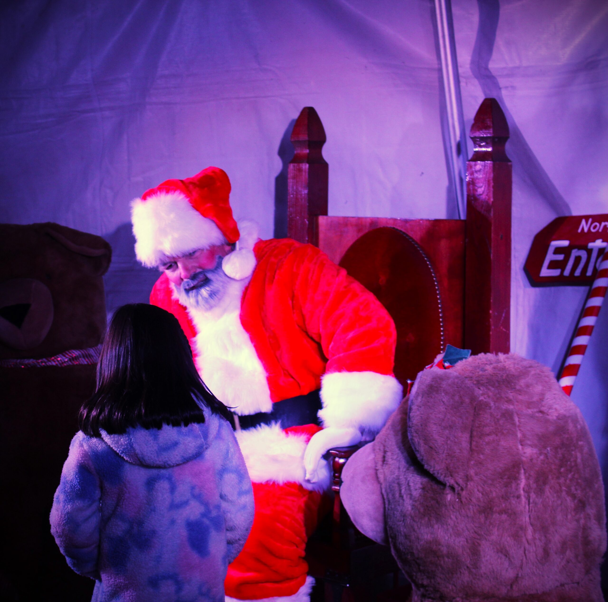 Santa talking to a child at the tree lighting