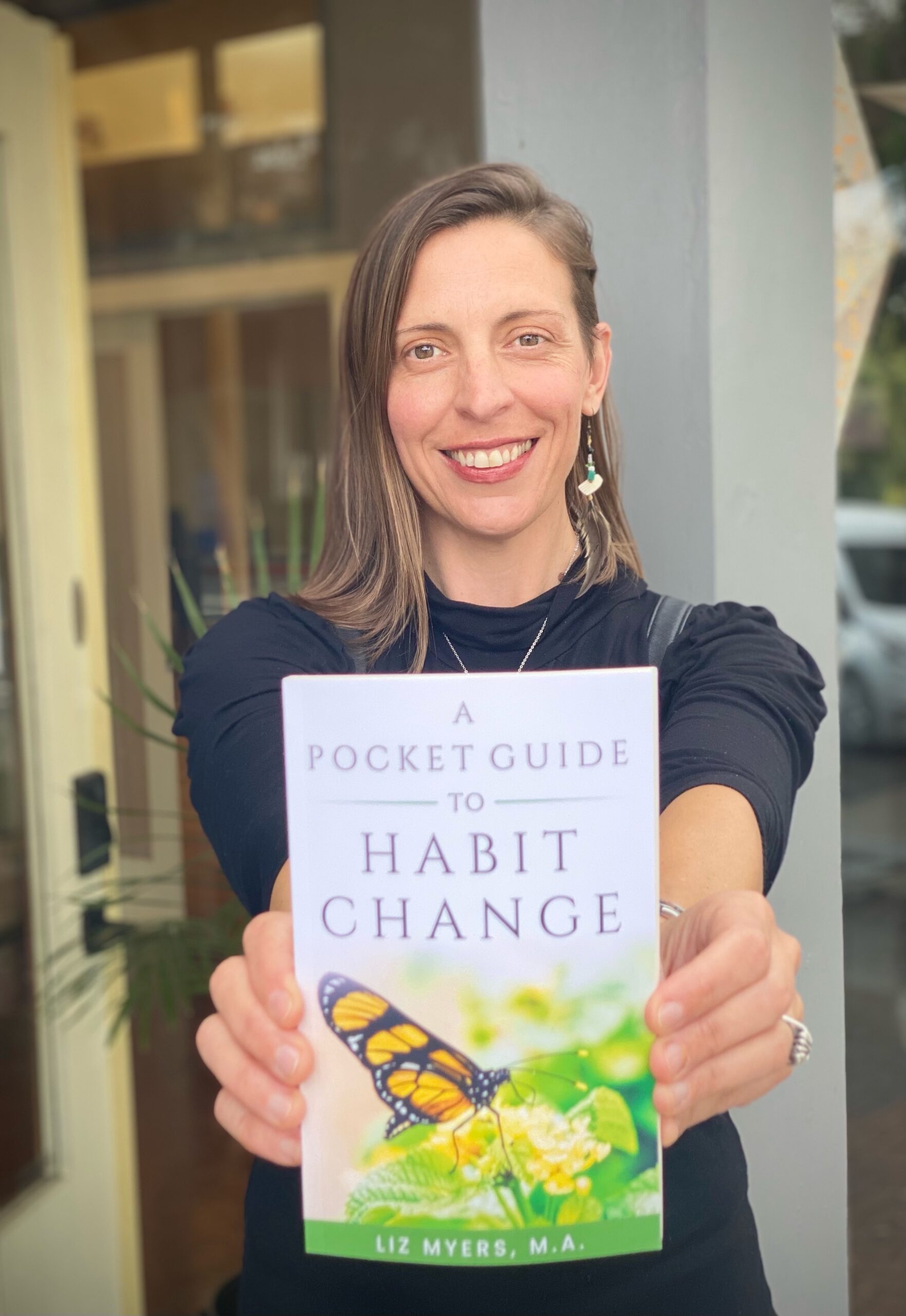 Rooted Living Wellness, Liz Myers with her book Habit Change photo